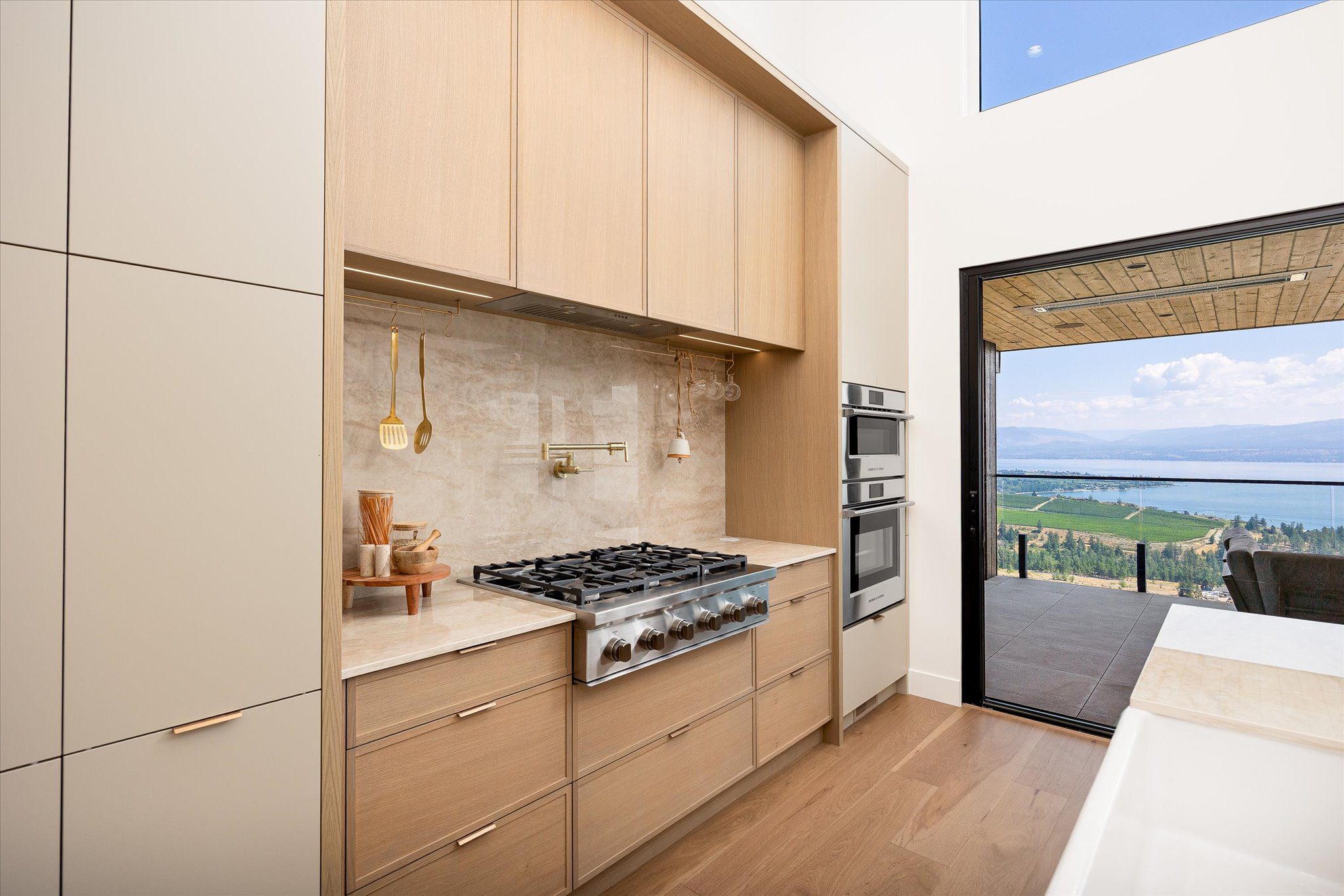 Modern kitchen featuring warm oak custom cabinets and natural wood grain textures.
