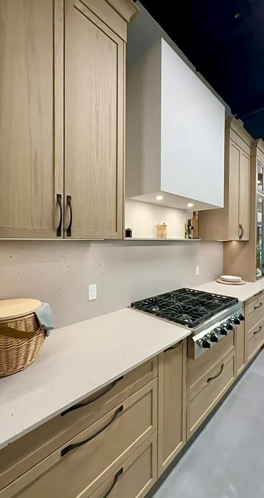 Wide view of a modern luxury kitchen featuring custom Westwood cabinetry and high-end kitchen cabinet accessories.