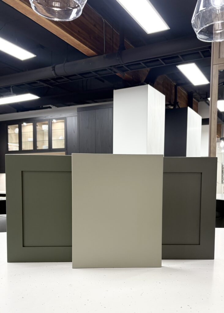 Three shaker style cabinet doors in various shades of green including deep herbal and sage tones to showcase timeless cabinet colours for a kitchen renovation.