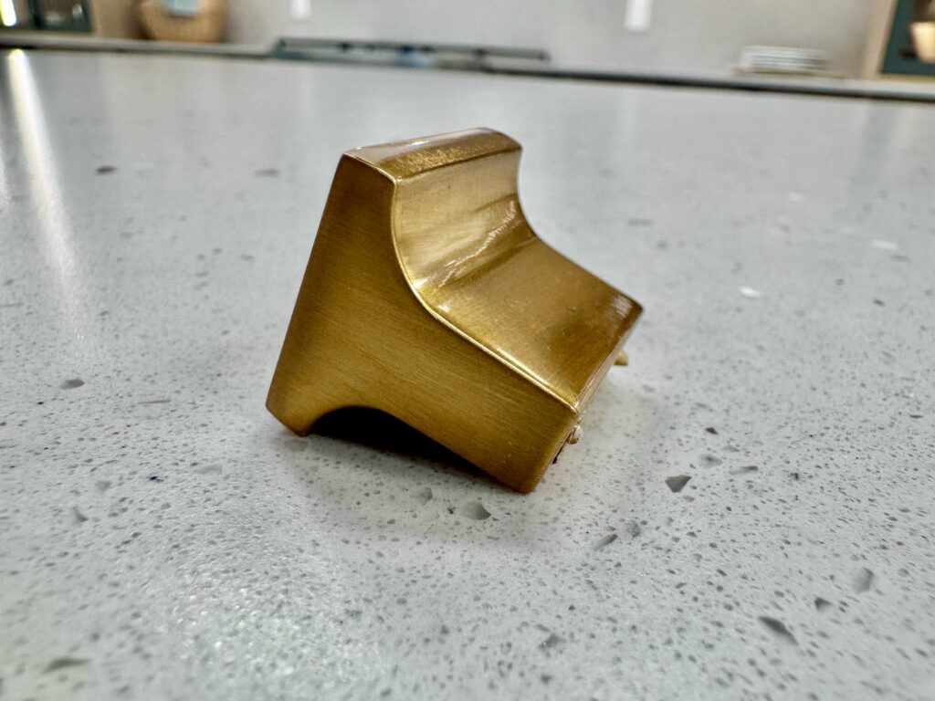 Gold cabinet knob showing anti-rotation nibs for secure cabinet hardware installation