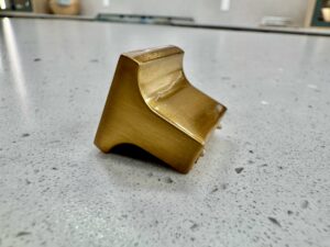 Gold cabinet knob showing anti-rotation nibs for secure cabinet hardware installation