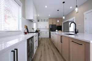 Custom kitchen cabinets in Kelowna featuring white and natural wood cabinetry with modern island design