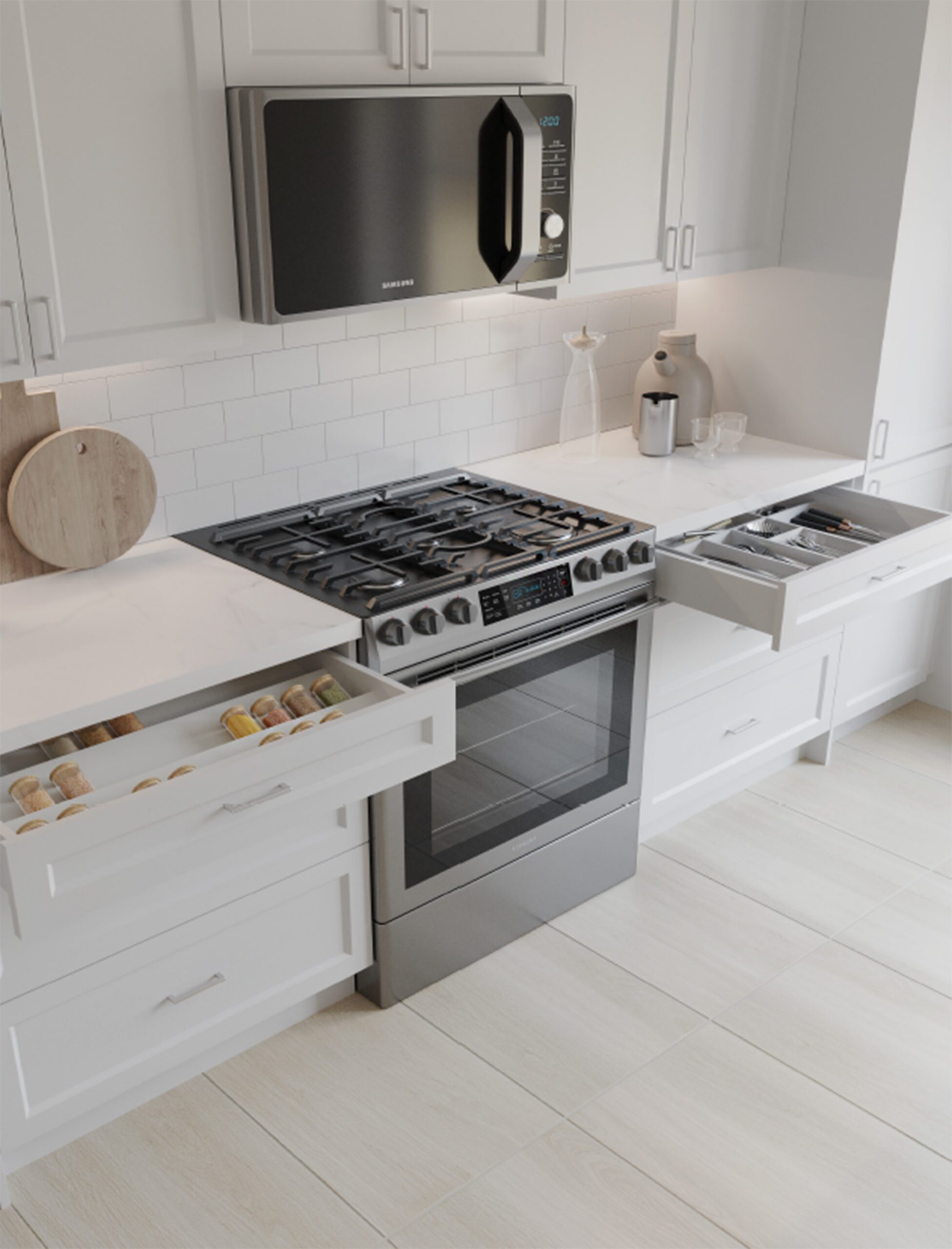 A high-angle, close-up shot of a modern kitchen counter featuring white Shaker-style cabinets and a white marble countertop. In the center is a stainless steel Samsung slide-in gas range with an over-the-range microwave mounted above it against a white subway tile backsplash. On the left, a drawer is pulled open to reveal organized spice jars, and on the right, another open drawer shows a built-in silverware organizer. Light wood flooring runs along the bottom.