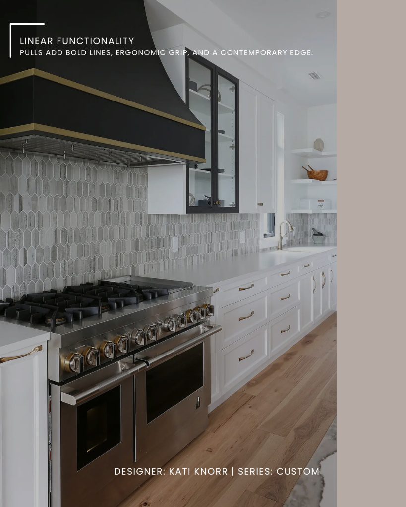 A modern white kitchen with black accents and linear custom cabinetry hardware on the drawers.